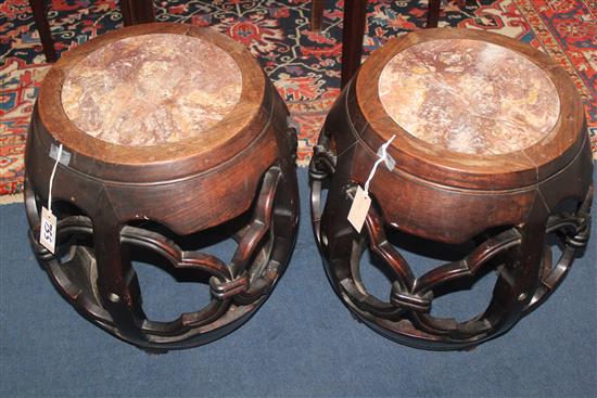 A pair of late 19th century Chinese marble inset rosewood barrel shaped stands or stools, H.53cm